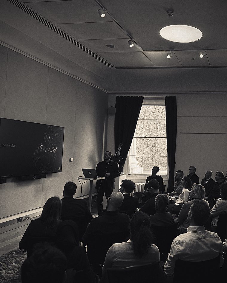 Tom Fleming speaking to a seated audience at a roundtable